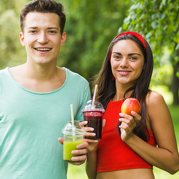 s_0000_smiling-couple-holding-avocado-apple-smoothies-hand.jpg